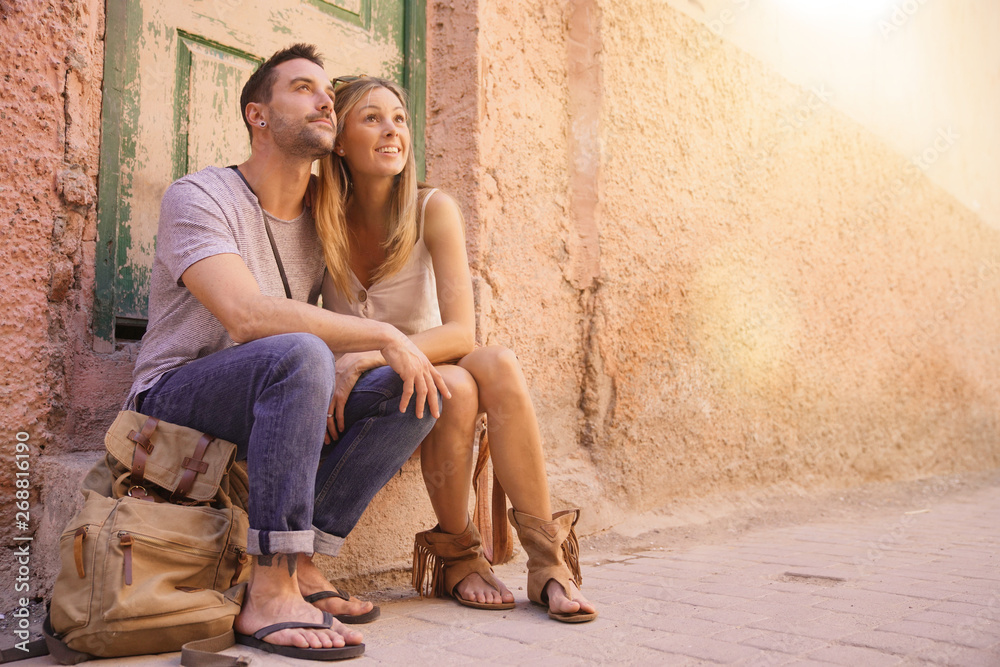 Couple of tourists sitting in street of Marrakech Couple of tourists sitting in street of Marrakech