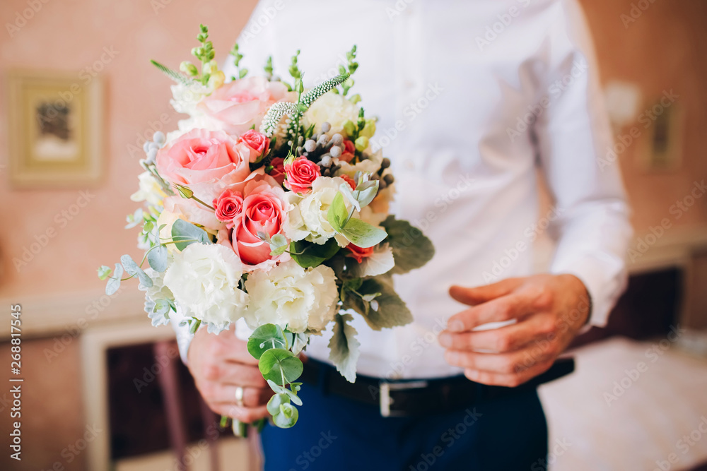 men's hands collect a bouquet. Florist's work. men's hands collect a bouquet. Florist's work.