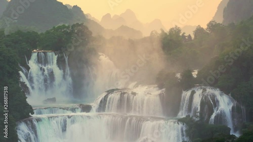 Sunset Bangioc waterfall in Vietnam and Detian waterfall in China, located near border, people can see this waterfall both of country. , Zoom out. photo