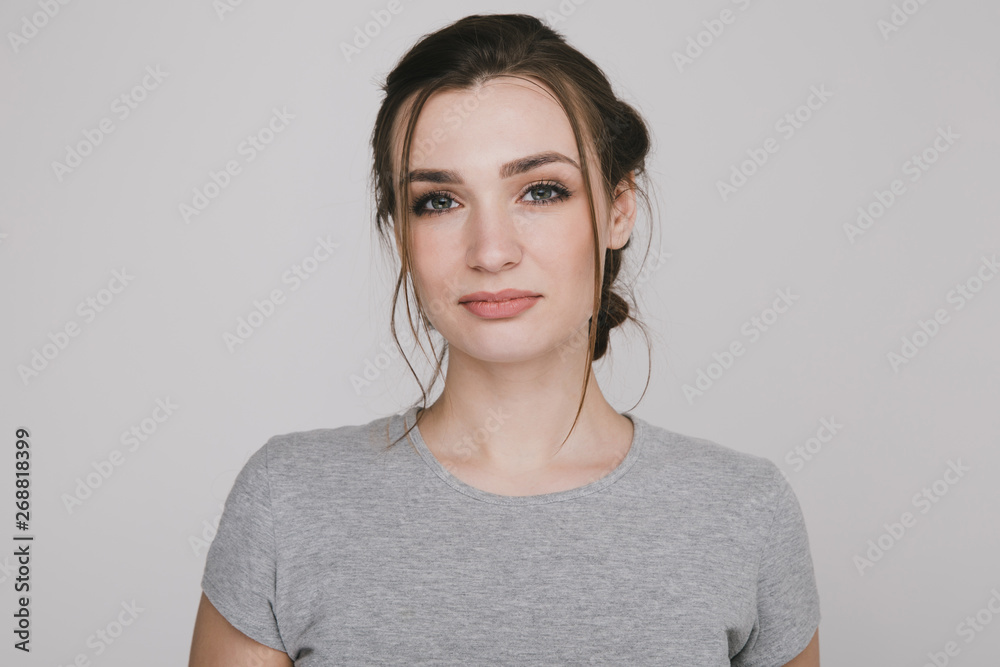Portrait of a nice woman posing isolated over the grey background Portrait of a nice woman posing isolated over the grey background