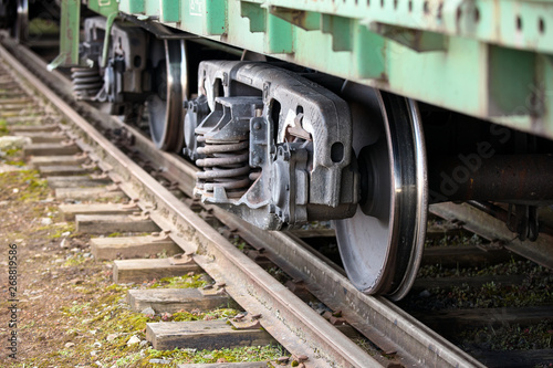 Dual gauge track example that allows the passage of trains of two different track gauges narrow-gauge railway and broad-gauge railway with freight wagon photo