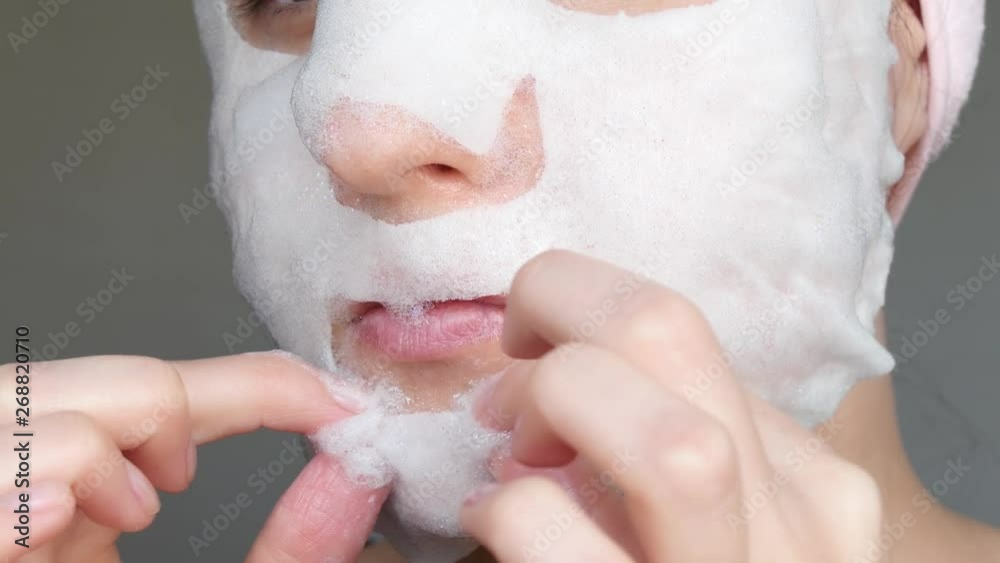 Woman is applying the bubble mask for face skin care. Skin care and cleaning. Anti-aging and cosmetics for the treatment of this skin problem . Woman is applying the bubble mask for face skin care. Skin care and cleaning. Anti-aging and cosmetics for the treatment of this skin problem .