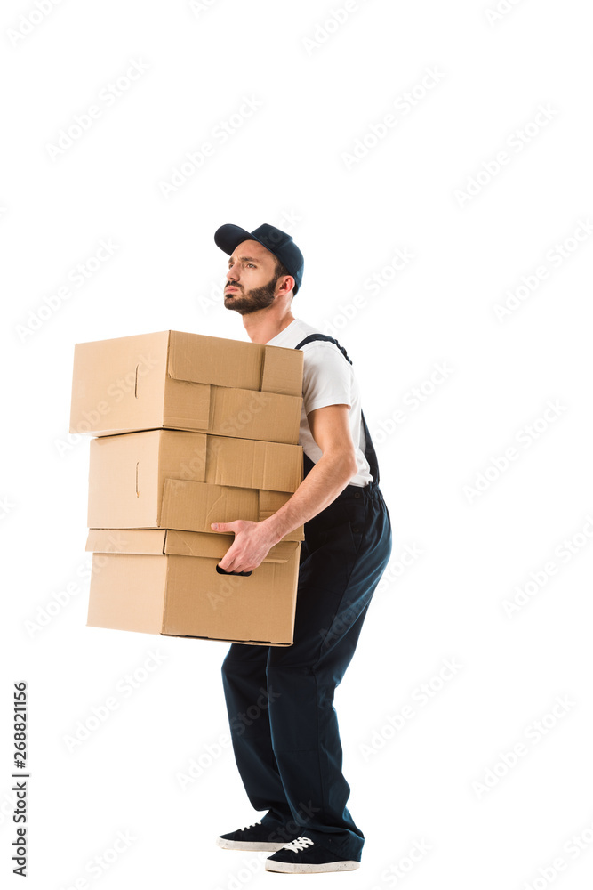 handsome serious delivery man carrying carton boxes isolated on white handsome serious delivery man carrying carton boxes isolated on white