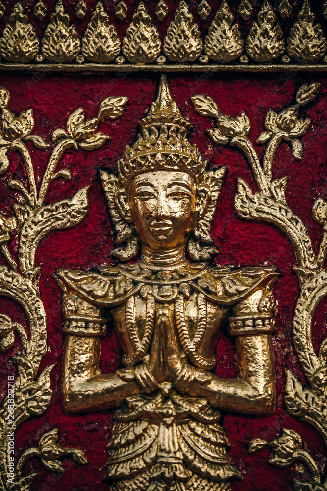 Golden Statue on the Doi Suthep Temple Wall in Chiang Mai