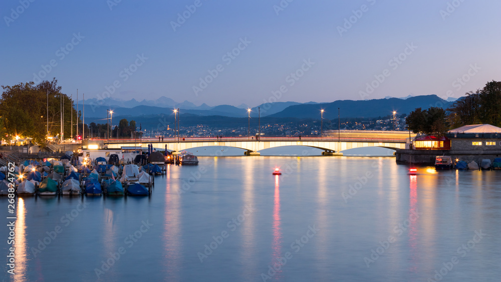 Quaibrucke or Quay Bridge across the Limmat river during sunset in Zurich