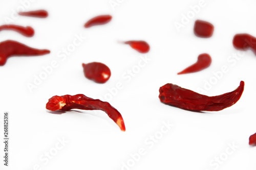 pods of red dried hot bitter edible pepper on a white background