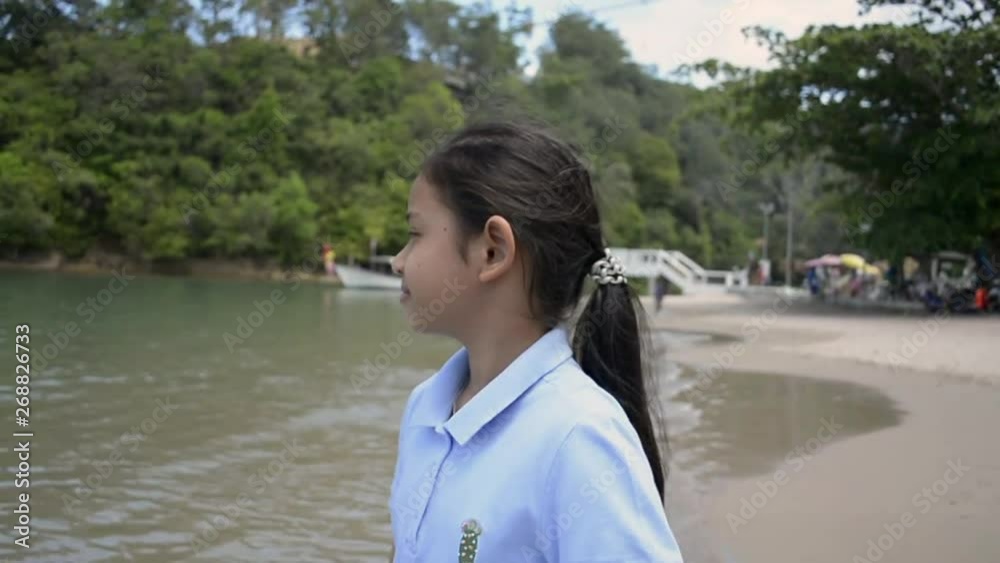 Cute girl walking happily on the beach, Slow motion. Cute girl walking happily on the beach, Slow motion.