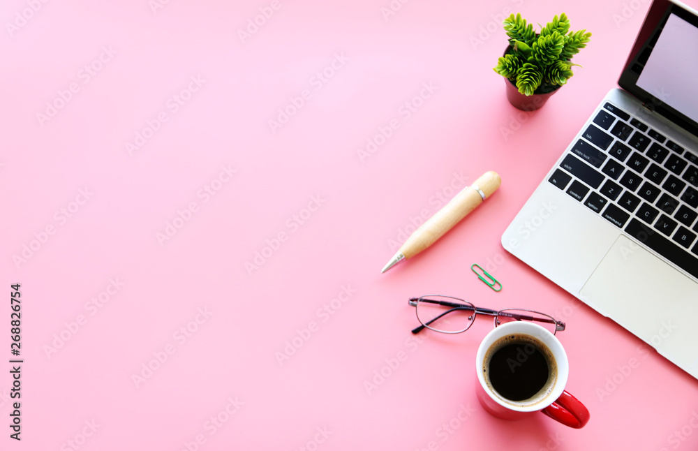 Working with Laptop computer,Hot coffee and cactus copy space on pink table background.Top view,Flat lay,style Minmal workspace,business Concept Working with Laptop computer,Hot coffee and cactus copy space on pink table background.Top view,Flat lay,style Minmal workspace,business Concept