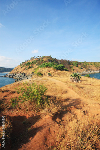 Beautiful seascape with sky twilight of sunset and sea horizon with Calm and blue sky.Dry grass field on mountain of Phrom Thep Cape is famous place in Phuket island, Thailand.