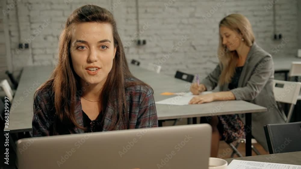 Woman using laptop and talking with corporate client Woman using laptop and talking with corporate client