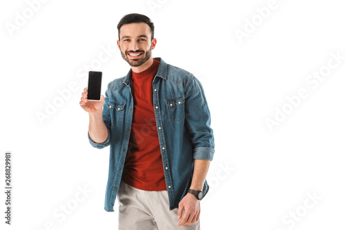 cheerful handsome man holding smartphone with blank screen and looking at camera isolated on white © LIGHTFIELD STUDIOS