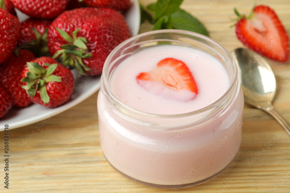 delicious strawberry yogurt in a jar and fresh ripe strawberries on a natural wooden table delicious strawberry yogurt in a jar and fresh ripe strawberries on a natural wooden table