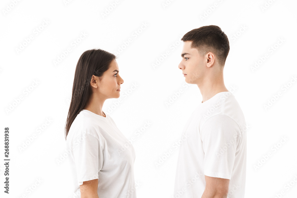 Attractive young couple standing isolated over white Attractive young couple standing isolated over white