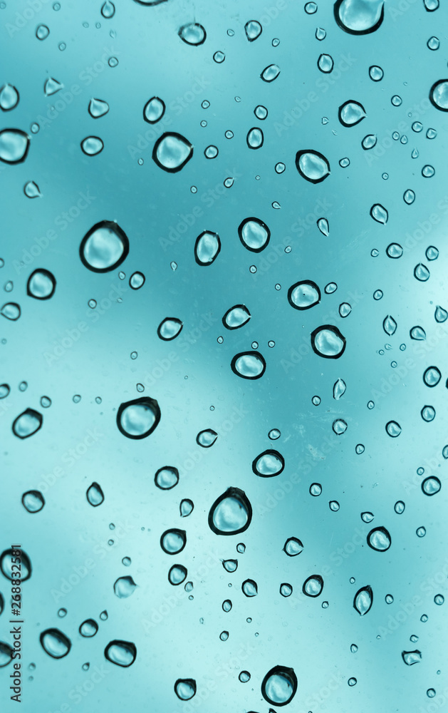 Blue background, Natural water drop on glass. Blue background, Natural water drop on glass.