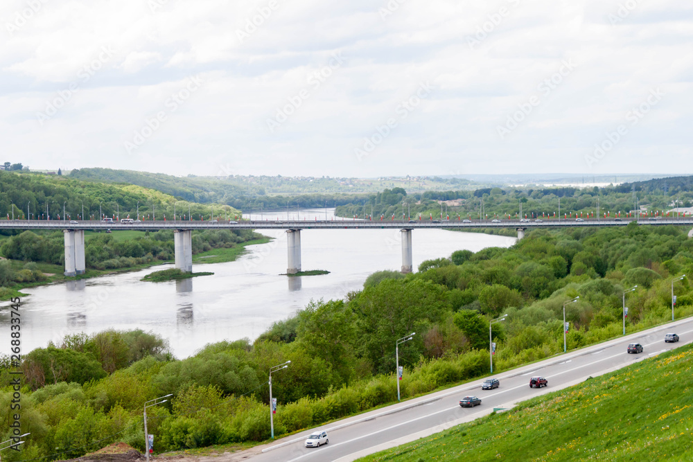 Kaluga, Russia - May 11, 2019: Entrance to the city and beautiful view of the bridge across The Oka river from the observation point in the Park of culture and recreation