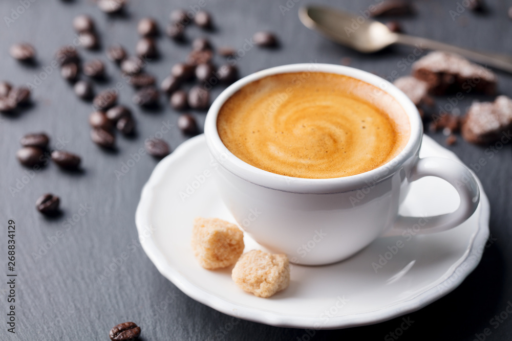 Fototapeta premium Cup of coffee on black slate background. Close up.