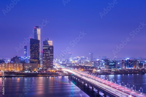 Seoul city and Cars passing on The bridge and Traffic, Han River at Night in Downtown Seoul, South Korea. © panyaphotograph