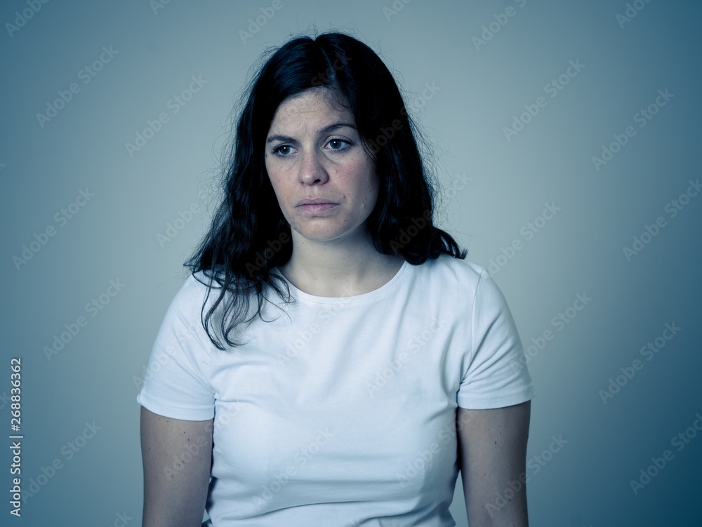 Portrait of sad and depressed woman. Isolated on neutral background. Human expressions and emotions Portrait of sad and depressed woman. Isolated on neutral background. Human expressions and emotions