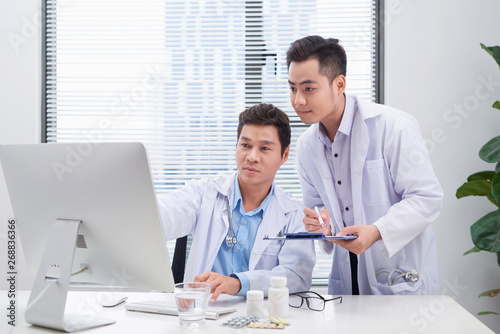 Two doctors discussing a patient's medical records