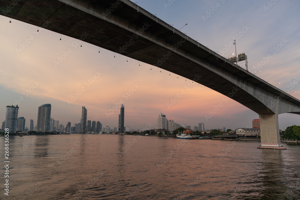 Fototapeta premium Rama3 bridge cross over Chao phraya river in evening Bangkok, Thailand. Cityscape Concept.