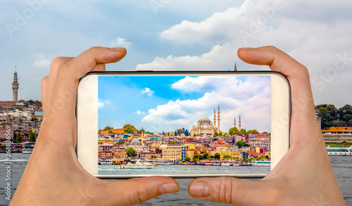 Photography Tourist taking a picture in front of   Golden Horn against Galata tower, Istanbu