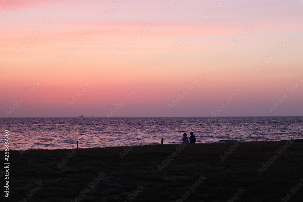 silhouette of couple on beach at sunset