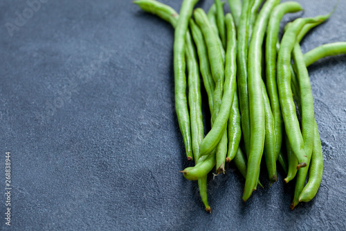 Green beans on grey stone background. Copy space.