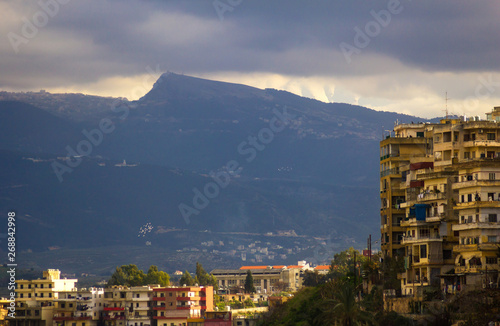 View of the city and mountains under a gloomy sky. Tripoli, Lebanon photo