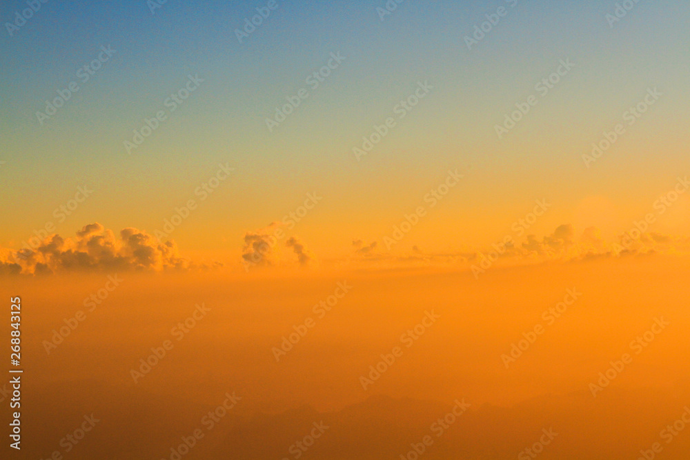Golden light with sunrise in morning on the sky and clound .Fog cover the jungle hill in Thailand Golden light with sunrise in morning on the sky and clound .Fog cover the jungle hill in Thailand