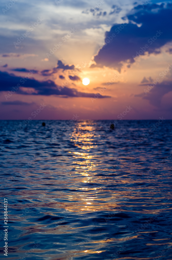 Fototapeta premium Amazing sea sunset, the sun, waves, clouds