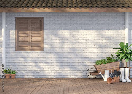 House terrace with garden equipment 3d render,There are empty white brick wall, wood floor and brown roof,Sunlight shining to the wall with tree shadow.