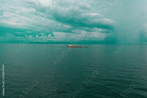 Fototapeta Naklejka Na Ścianę i Meble -  Aerial drone view of sea water and rocks over cloudy sky background