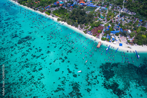 Aerial drone view of beautiful tropical Koh Lipe island with crystal clear lagoon sea water during sunny summer day  Thailand