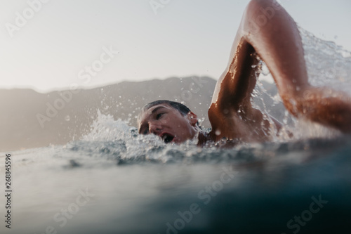 Young teenager swimming in the sea photo