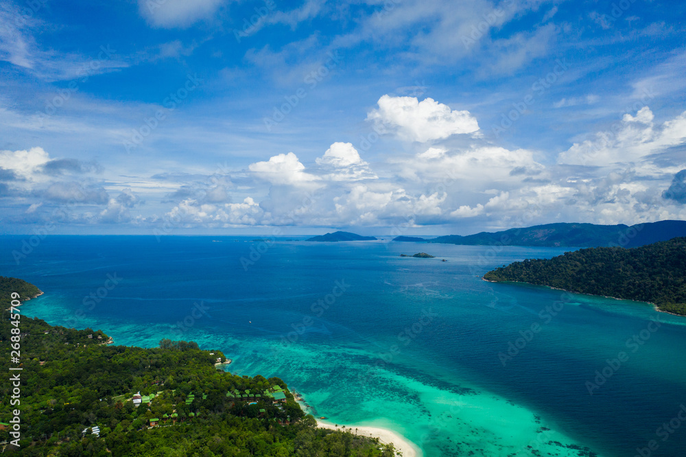 Aerial drone view of beautiful green Koh Usen island with amazing lagoon sea over summer sky background, Thailand Aerial drone view of beautiful green Koh Usen island with amazing lagoon sea over summer sky background, Thailand