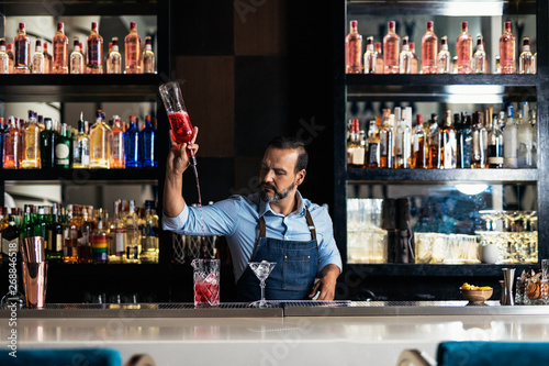 Professional young bartender working