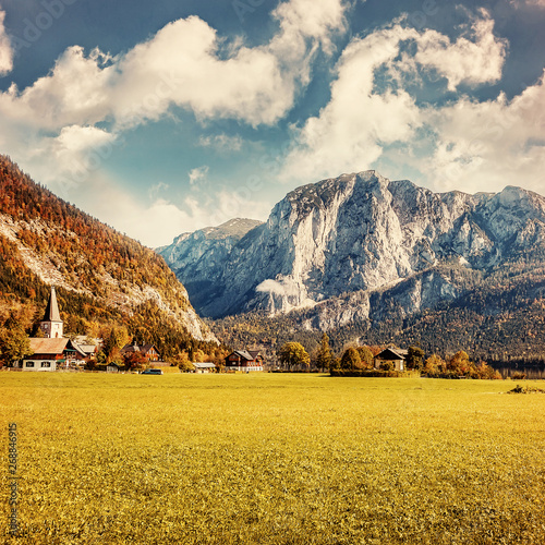 Awesome alpine highlands in sunny day. Altaussee village surrounded by Rocky Mountains of Sunny Day. perfect sky over the Trisselwand peak. Incredible Austrian Alps valley. instagram creative style