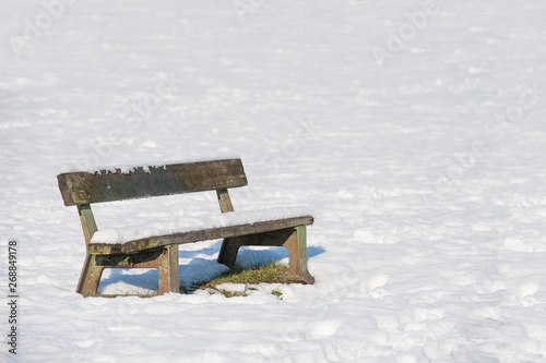 snow covered park bench