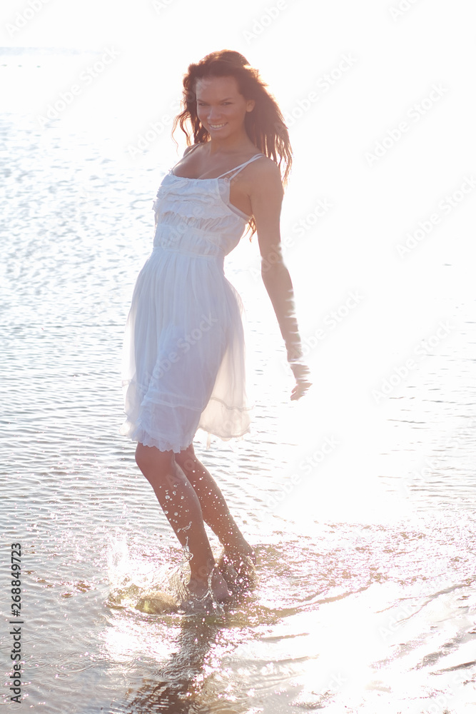 Young slim woman dressed in white sundress Young slim woman dressed in white sundress