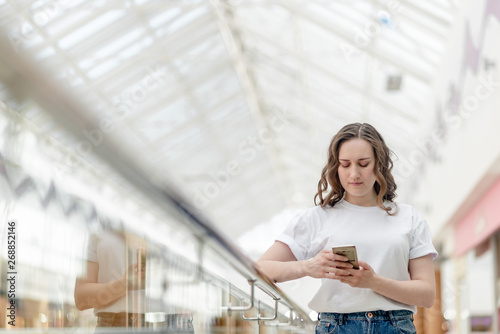 Young woman with phone in her hand making selfie. Portrait, happy smile, beauty and technology concept Free Download Young woman with phone in her hand making selfie. Portrait, happy smile, beauty and technology concept - GFXLoad
