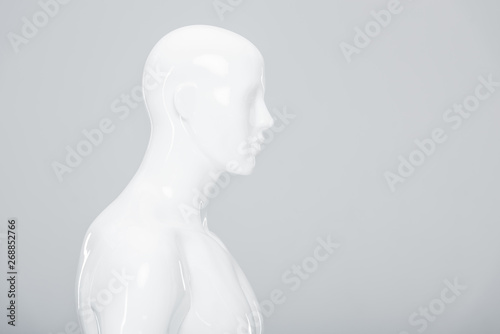 white plastic mannequin isolated on grey with copy space photo