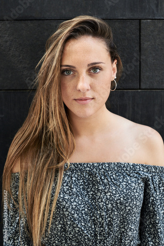 Portrait of beautiful blonde girl wearing blouse with shoulders out.