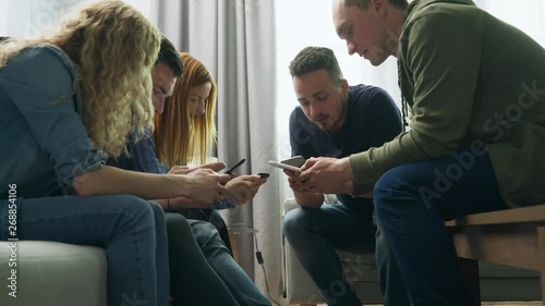 Wallpaper Mural A group of friends use smartphones in the living room Torontodigital.ca