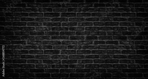 Black brick wall texture. Aged stone block masonry. Dark gloomy background