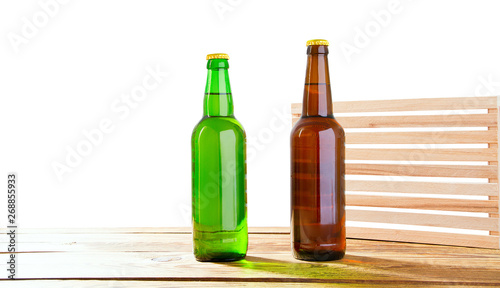 Photo of two different full beer bottles with no labels. Separate clipping path for each bottle included.2 two separate photos merged together. Glass bottles odifferent beer on light white background