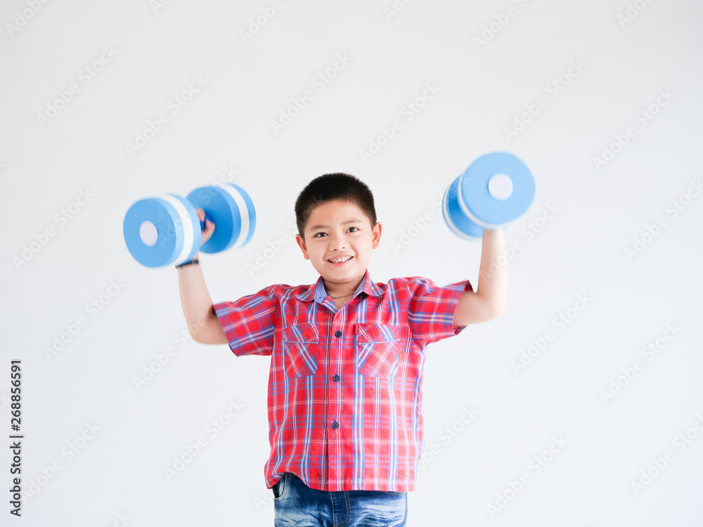 Asian little boy with blue color dumbbell on white background Asian little boy with blue color dumbbell on white background