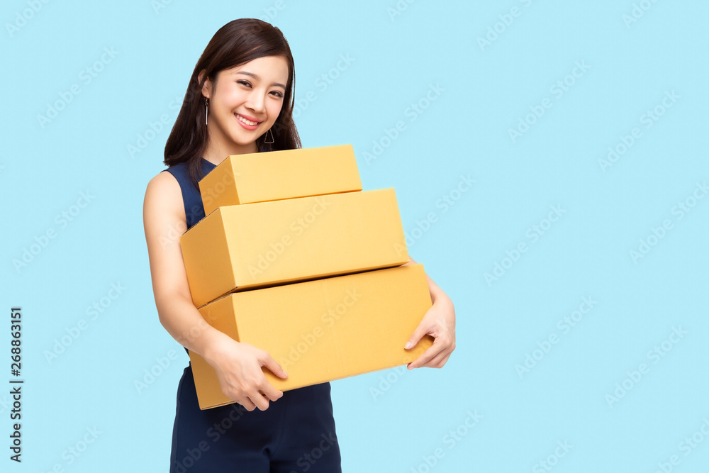 Happy Asian woman holding package parcel box, Delivery courier and shipment service concept Happy Asian woman holding package parcel box, Delivery courier and shipment service concept