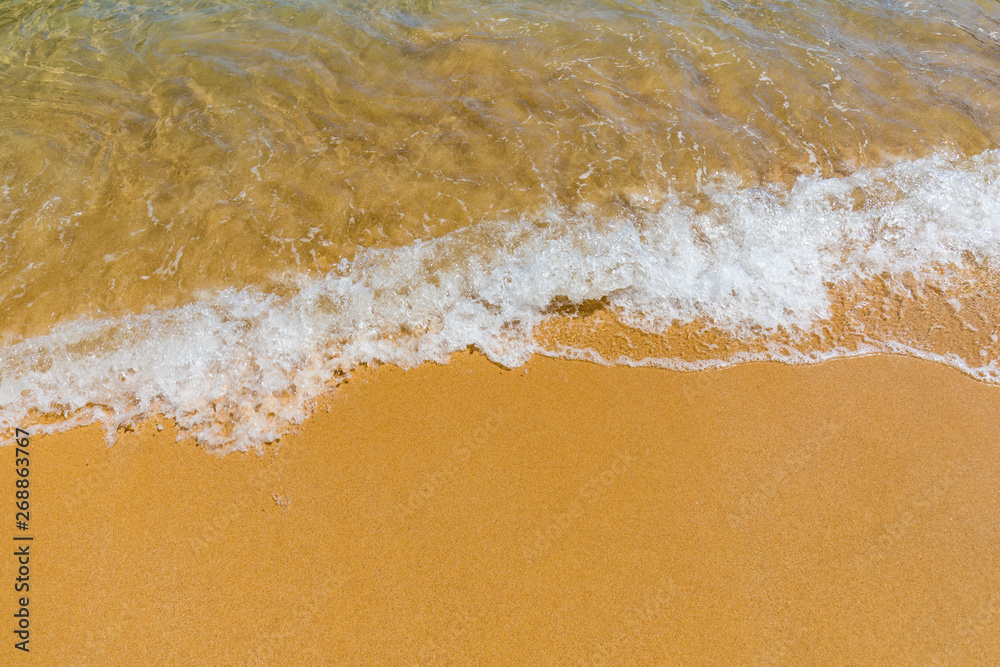 Soft wave of blue ocean on sandy tropical beach. Background of tropical paradise beach with golden sand, travel tourism panorama background concept. Sand and sea waves background. Soft wave of blue ocean on sandy tropical beach. Background of tropical paradise beach with golden sand, travel tourism panorama background concept. Sand and sea waves background.