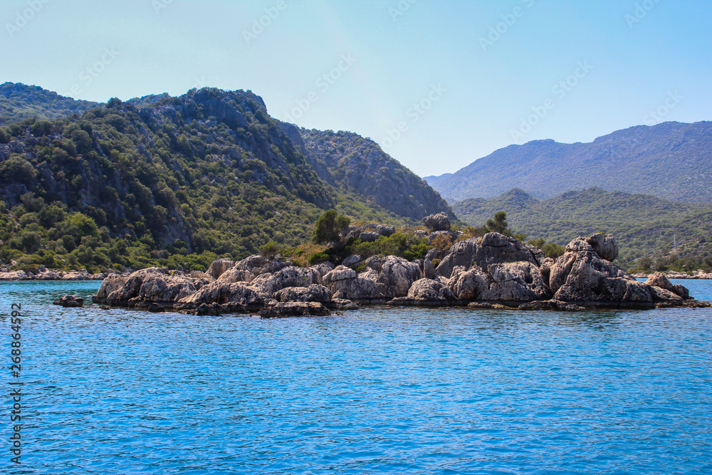 Rocks and bright turquoise water in the Mediterranean Sea.