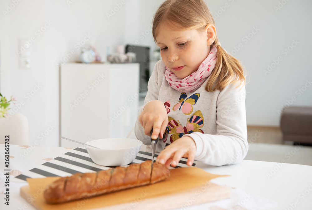 Cute little girl eating soup with whole grain bread at home Cute little girl eating soup with whole grain bread at home